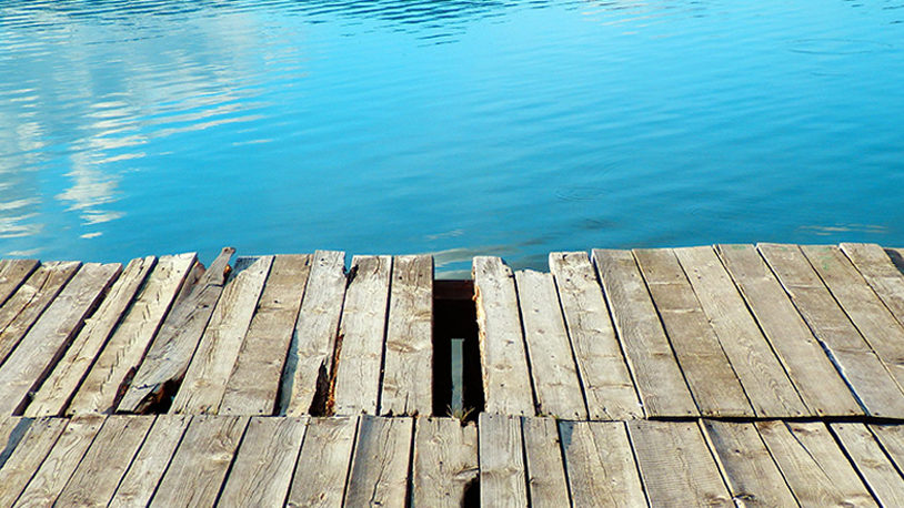 A weathered deck along the water