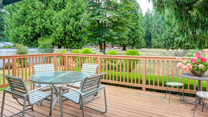 Backyard deck with table and safety railings