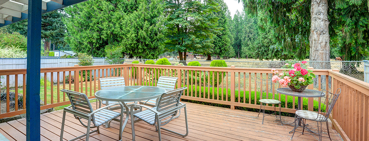 Backyard deck with table and safety railings